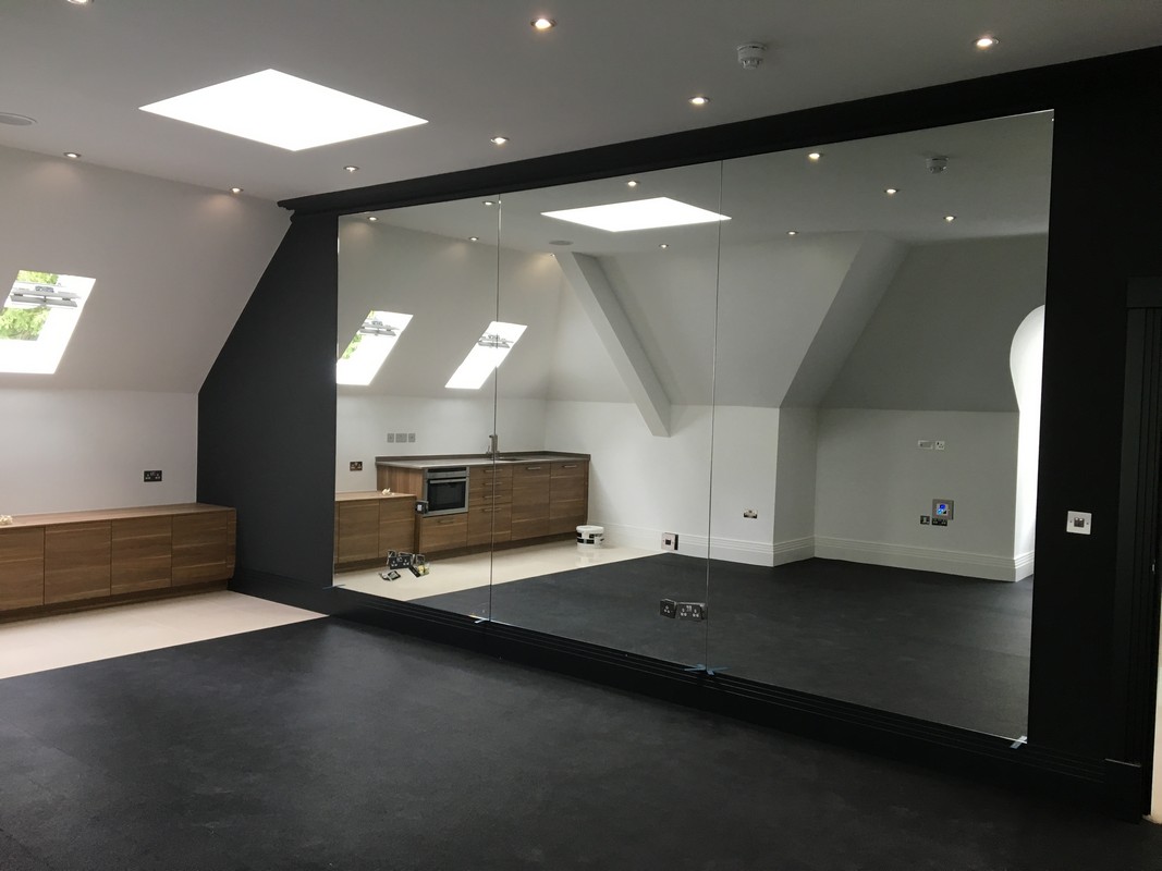 Frameless glass wall dividing loft conversion in Thornton Heath